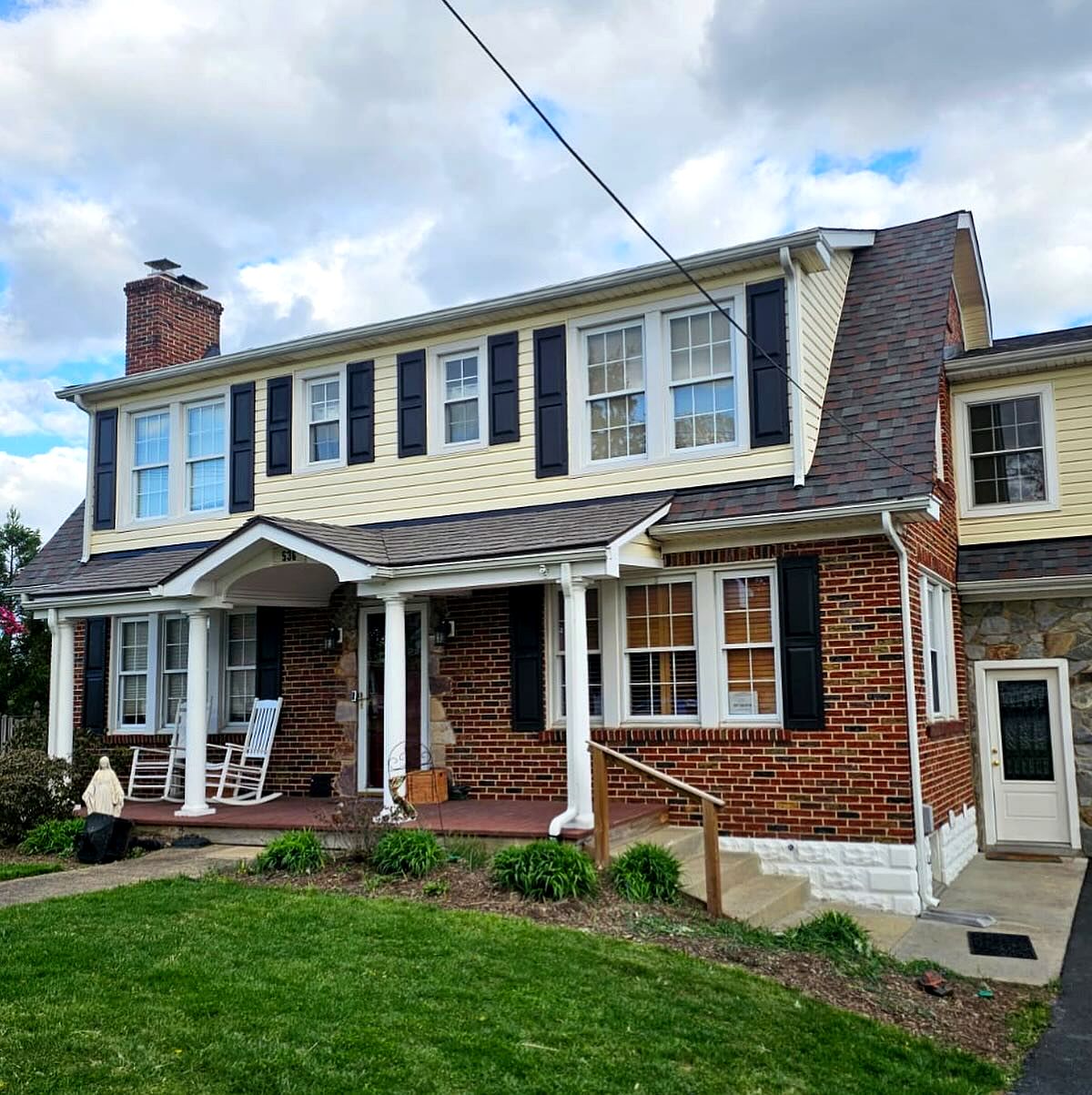 Brick colonial with a new dark shingle roof