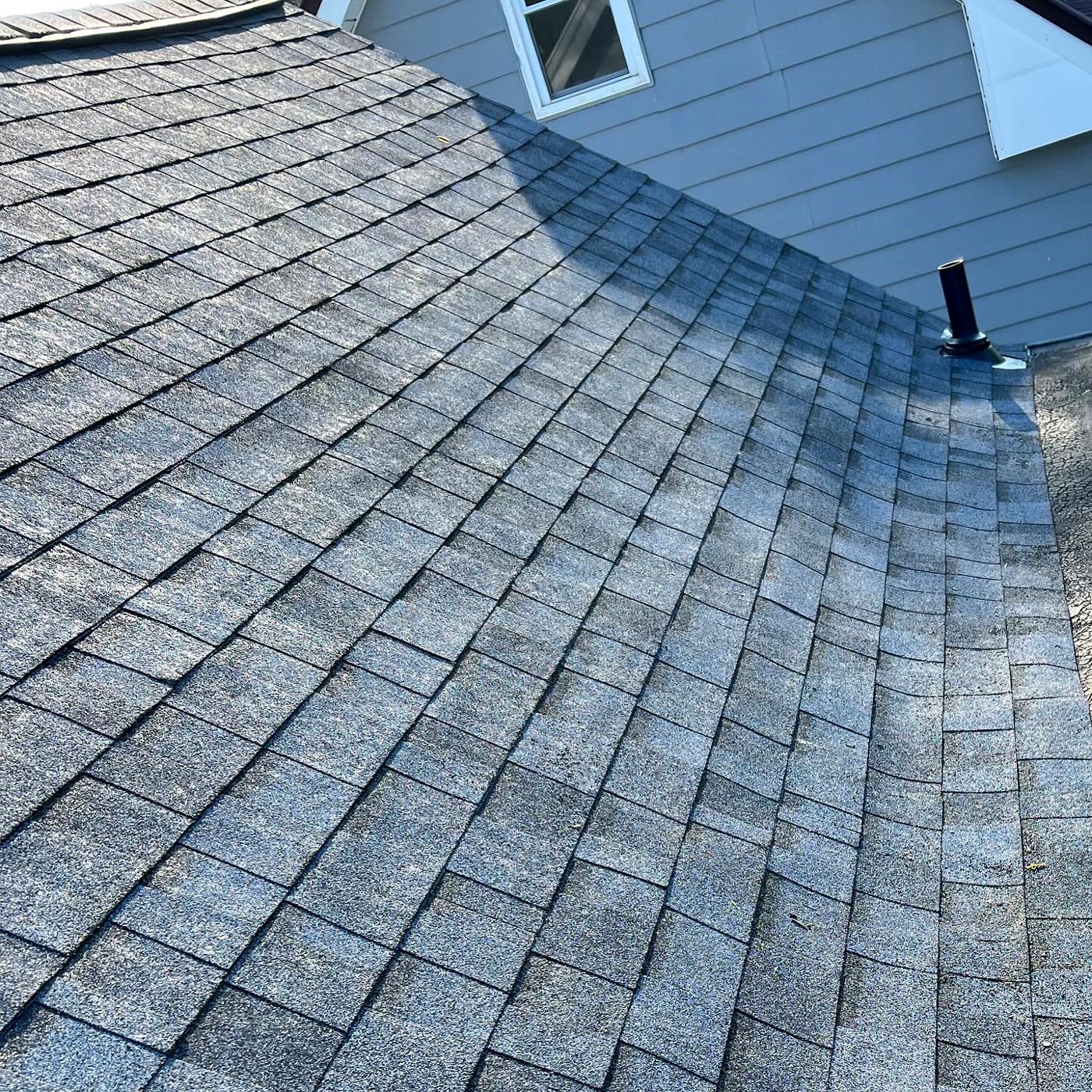 New gray shingles meeting a dormer wall