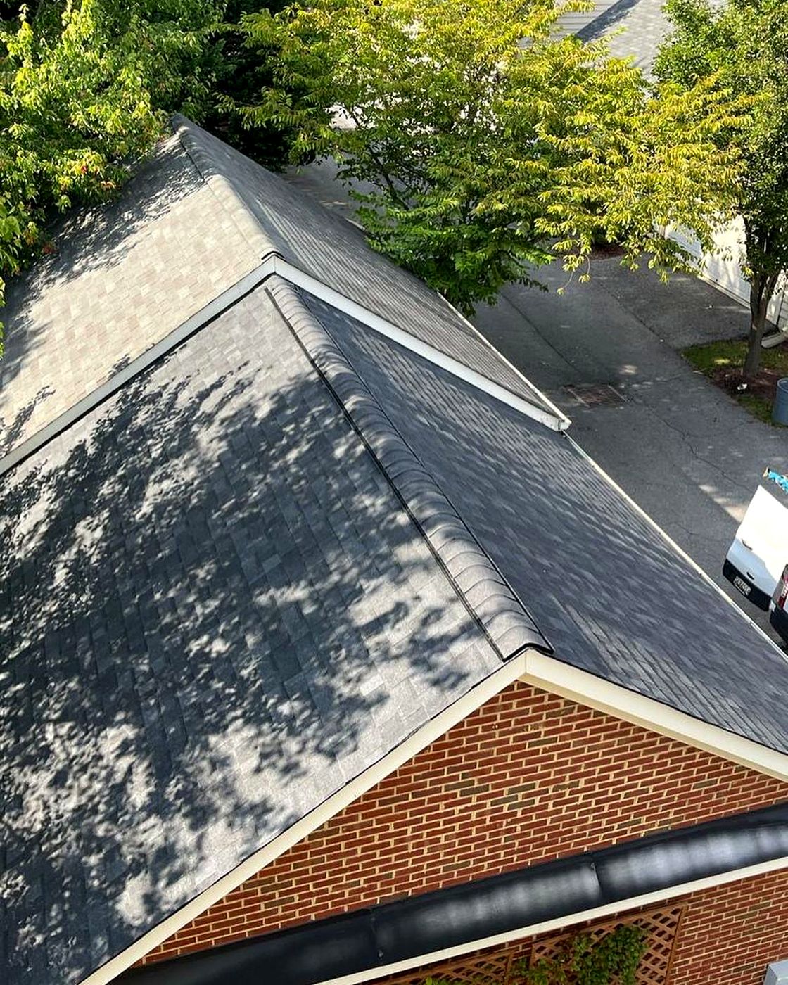 Hip roof over a brick home from above