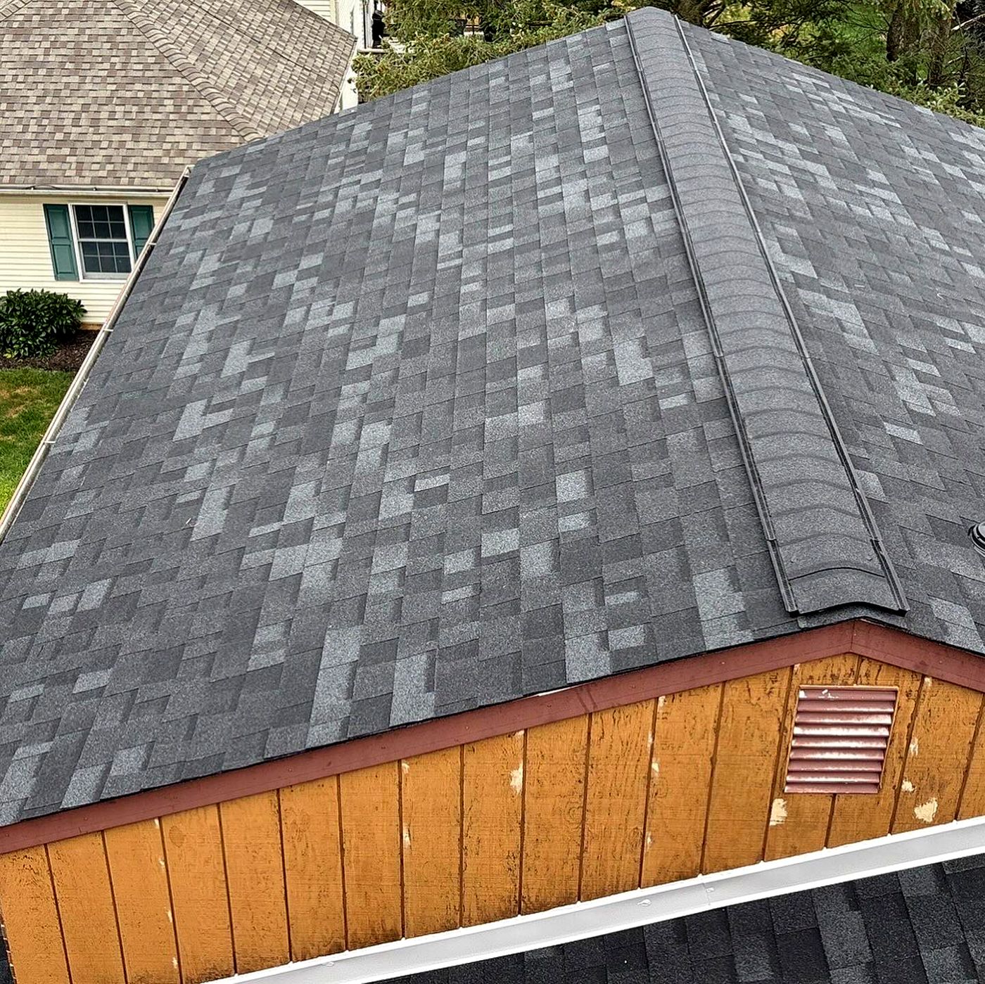 Finished hip and gable roof over wood siding