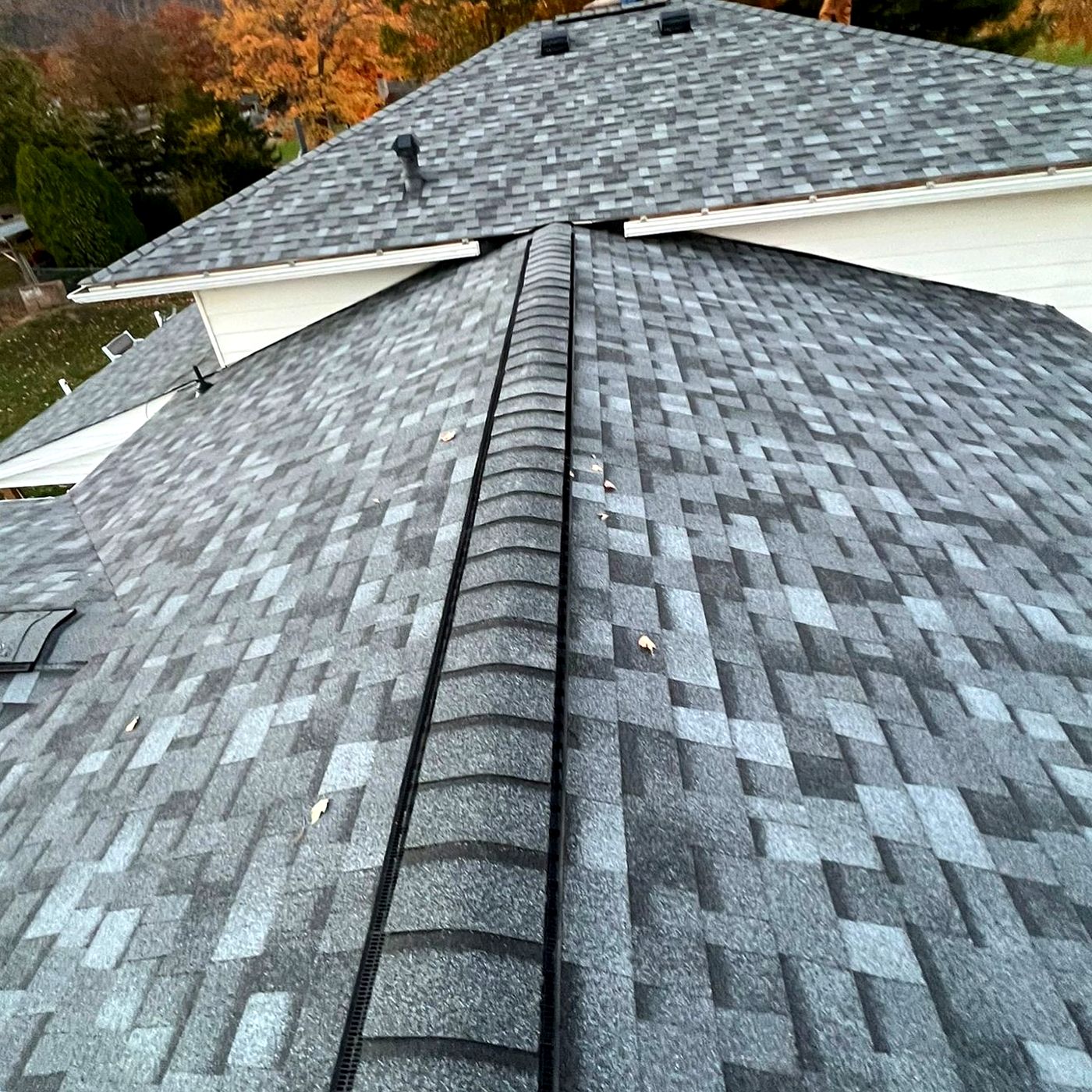 Ridge cap on a finished roof at dusk