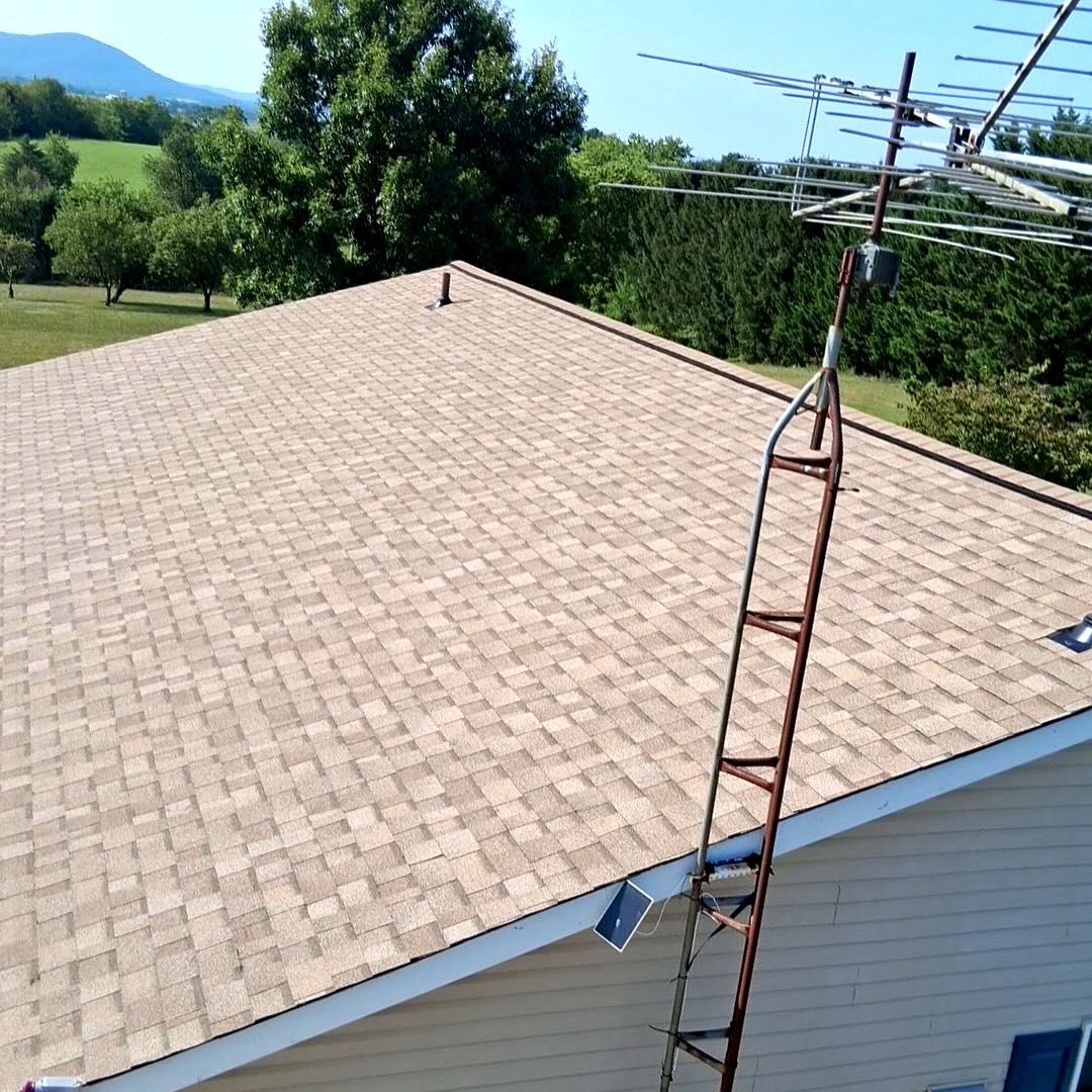 Finished tan shingle roof in a rural setting