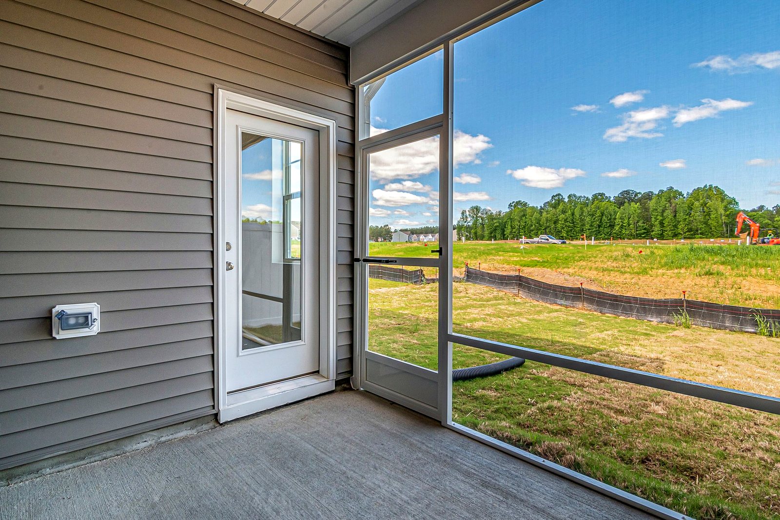 Full-glass hinged door opening onto a screened back porch