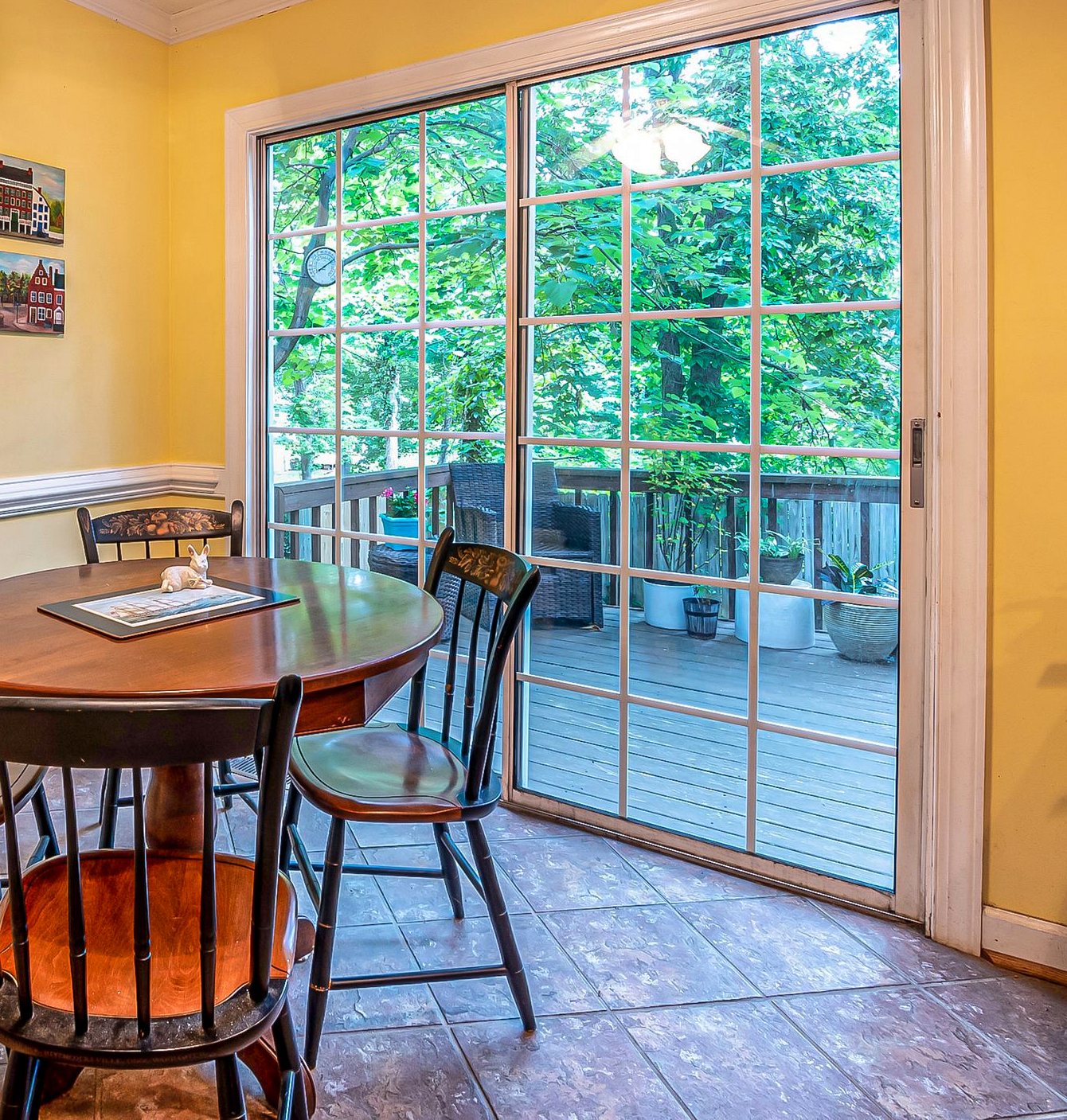Sliding glass patio door with grilles opening from the kitchen onto a deck