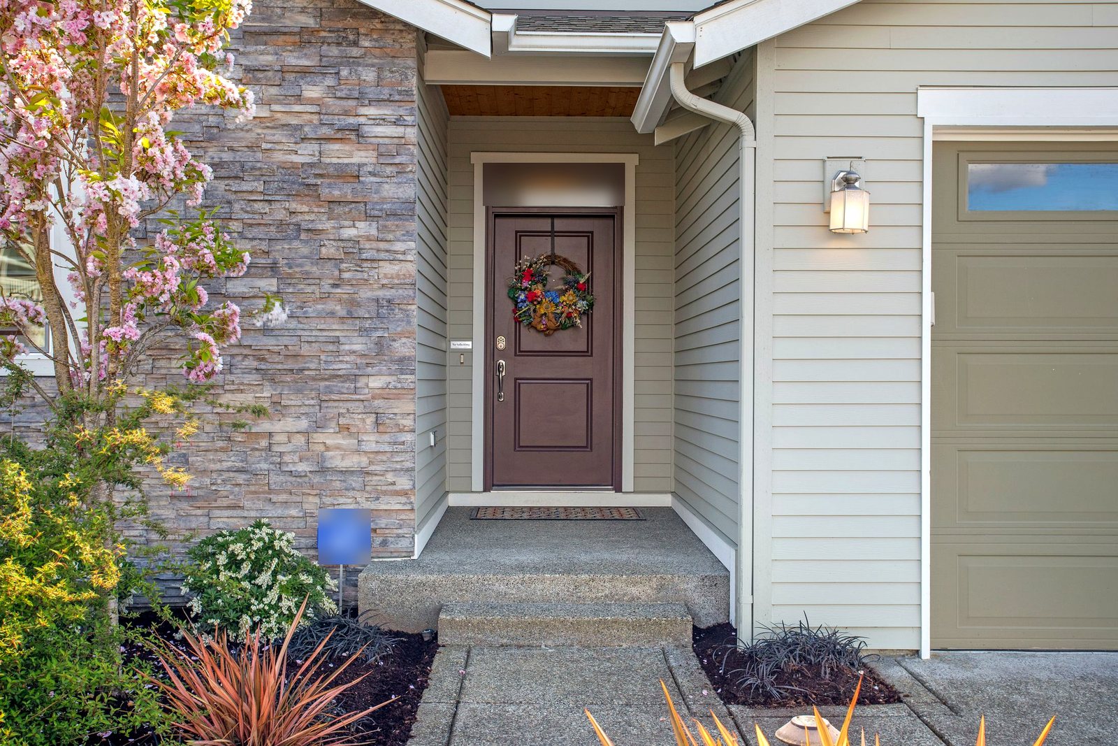 Recessed front entry with a paneled door, transom and new trim