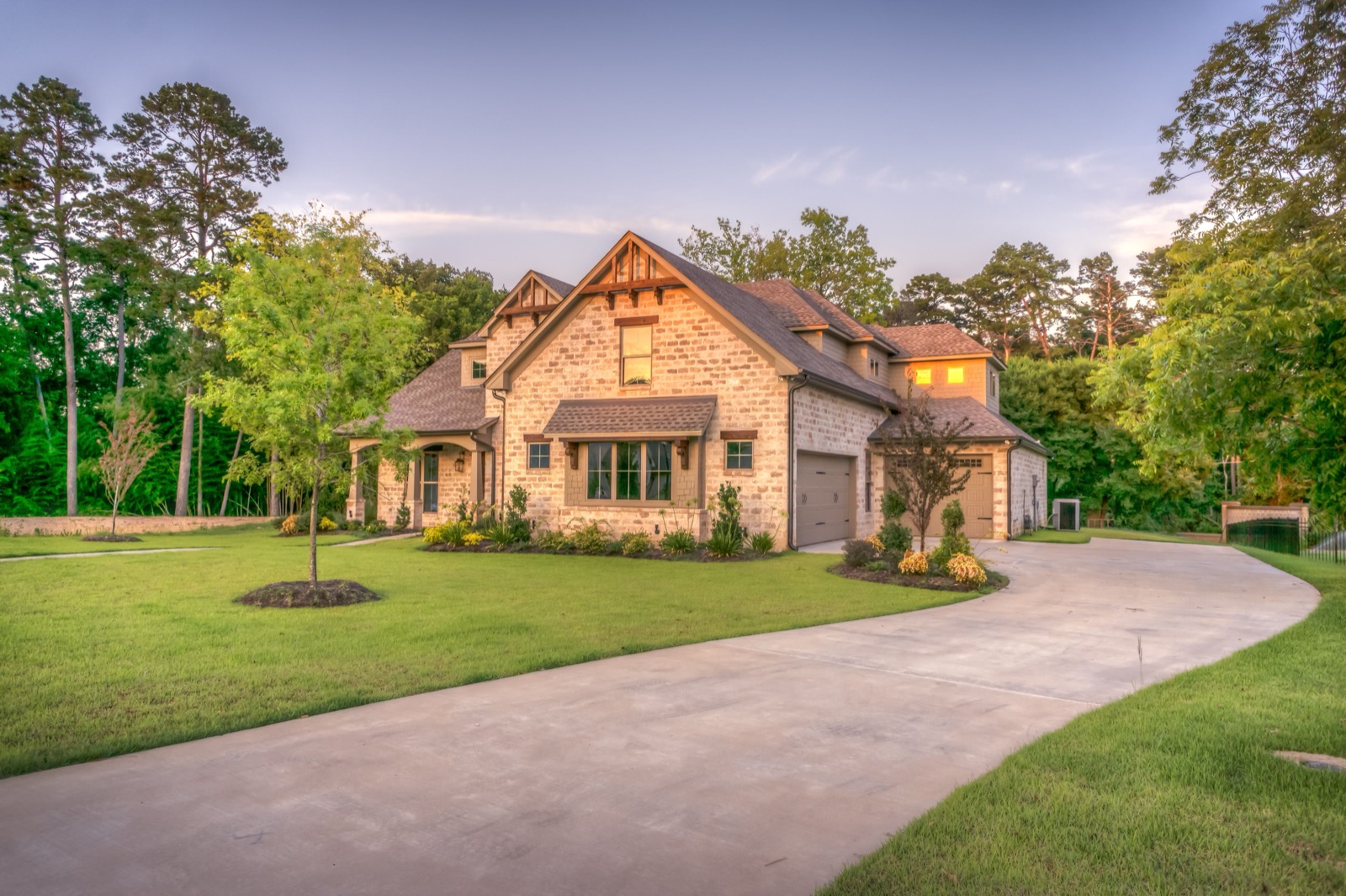 Large stone estate with gutters and downspouts along every roof line