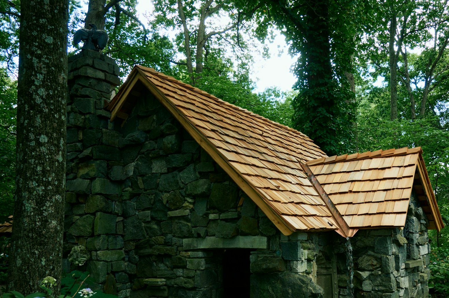New cedar-shake look roof on a stone cottage