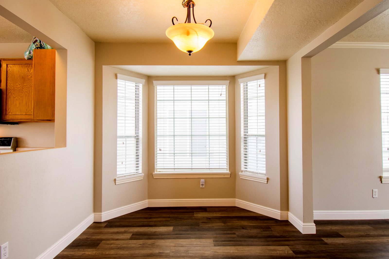 Three-unit bay window projecting out from a dining nook