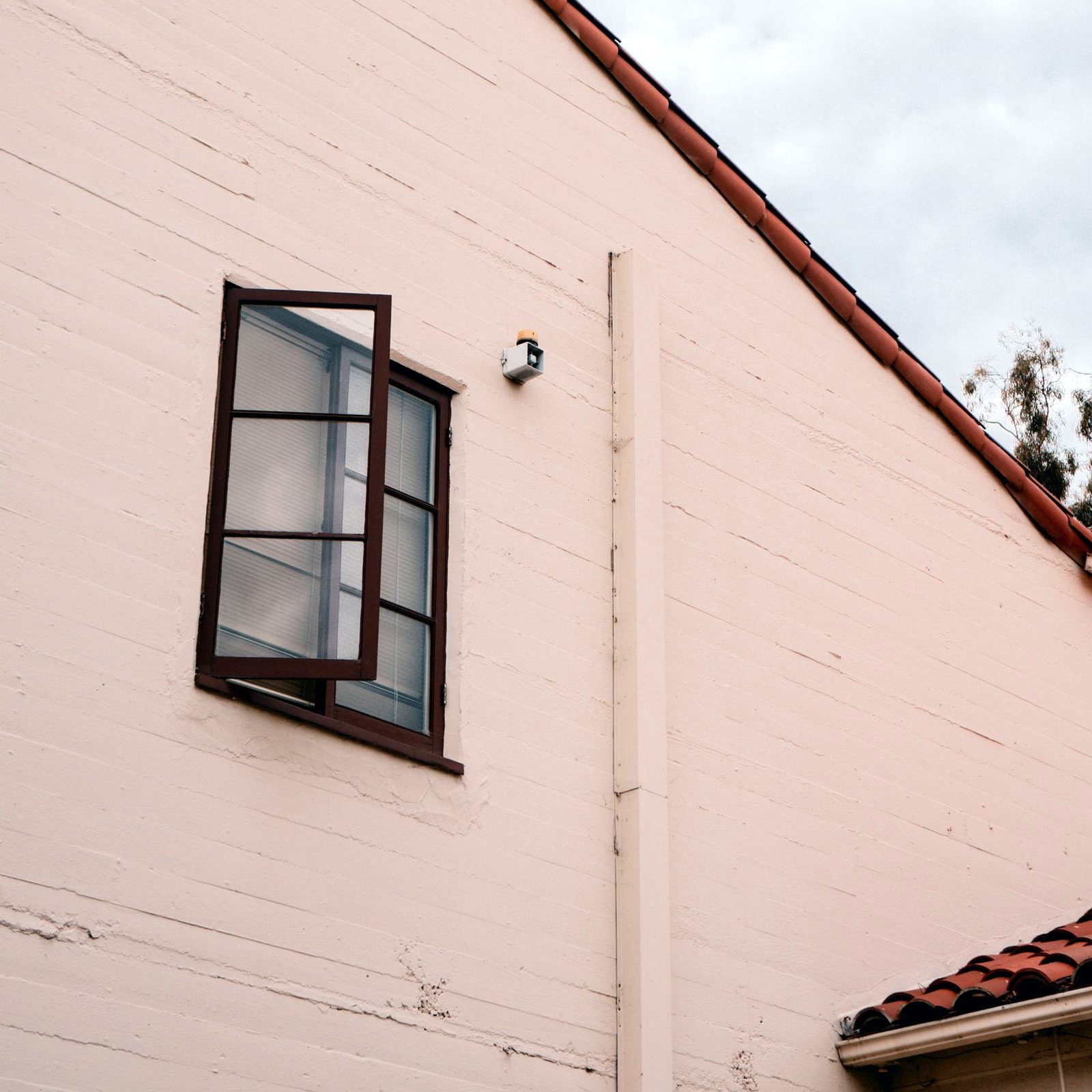 Side-hinged casement window swung open outward
