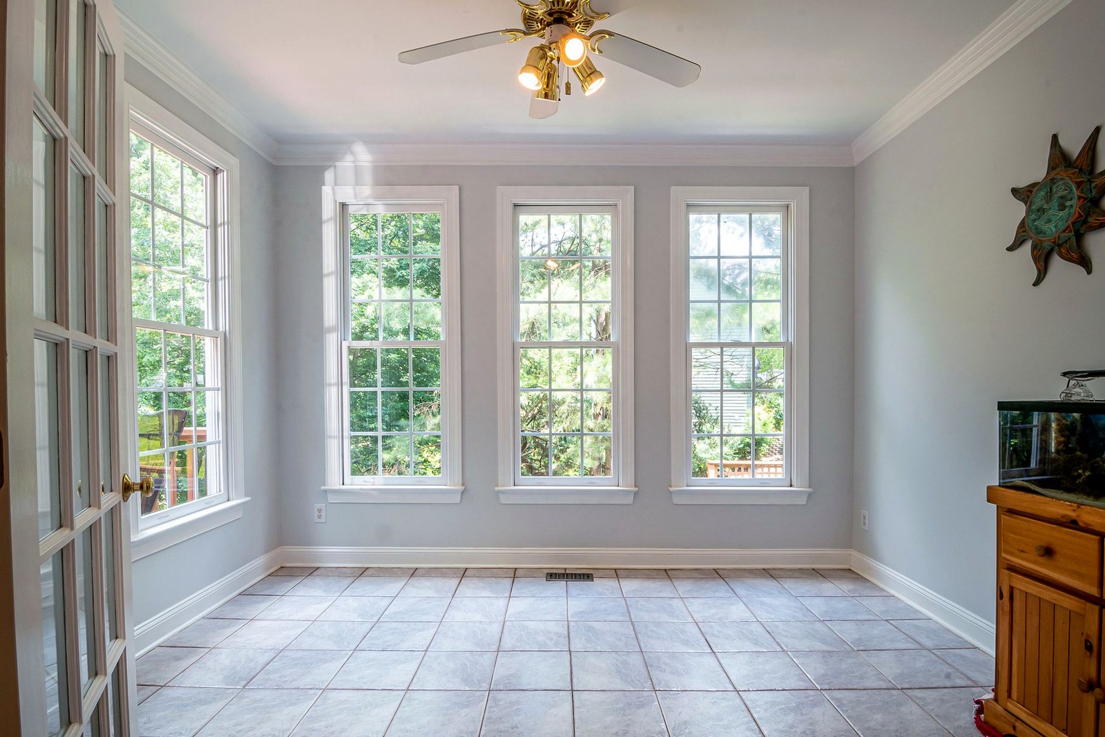 Room with three white double-hung windows with grilles